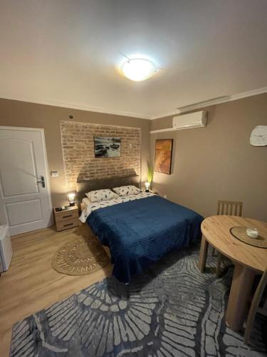 a bedroom with a bed and a brick wall at Hostel Anton in Tivat