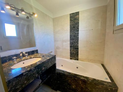 a bathroom with a sink and a bath tub at La Bastide in Saint-Saturnin-lès-Apt