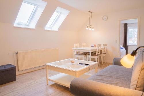 a living room with a couch and a table at Schleiblick App 19 in Rabenkirchen-Faulück