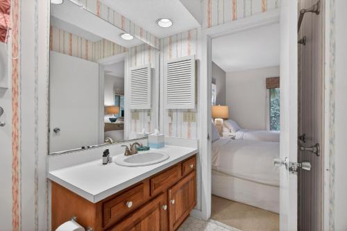 a bathroom with a sink and a mirror and a bed at IC106: 106 Inlet Cove in Kiawah Island