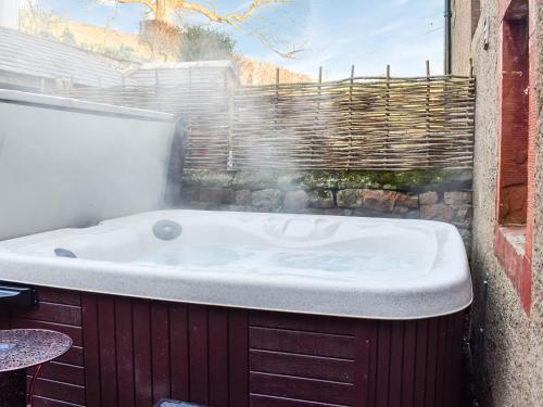 a bath tub with smoke coming out of it at Staffield Cottage - Uk35714 in Kirkoswald
