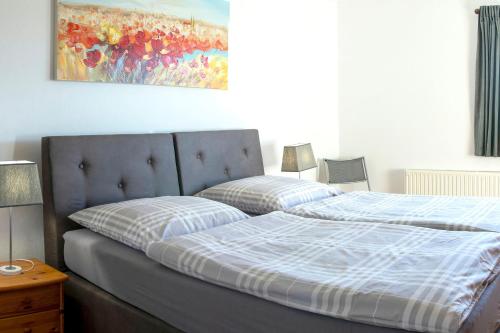 a bedroom with a bed and a painting on the wall at Ferienwohnung Klein Süstedt in Klein Süstedt