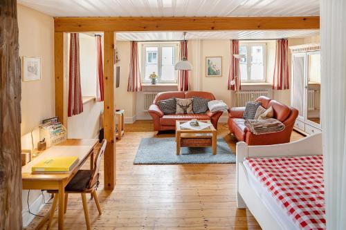 a living room with a couch and a table at Haus Belchenwind in Münstertal