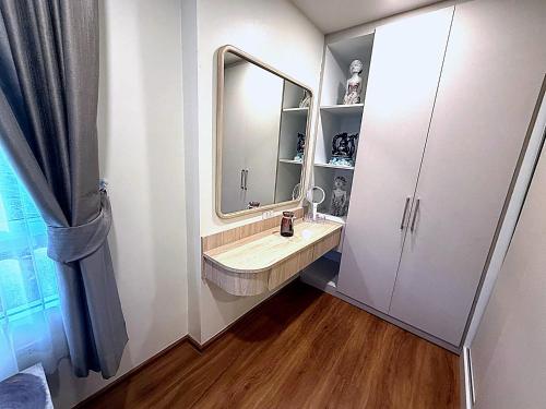 a bathroom with a sink and a mirror at Modern Apartment with Queen Bed in Living Room & Separate Bedroom in Lamai
