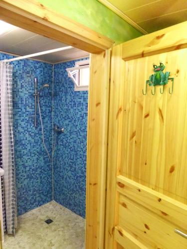 a bathroom with a shower with blue tiles at Villa-Hufeland in Berlin