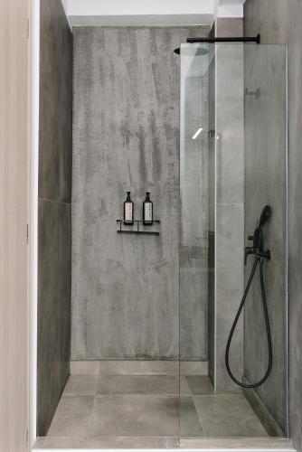 a shower with two bottles on a shelf in a bathroom at SunBlue Boutique Villas in Skala Rachoniou