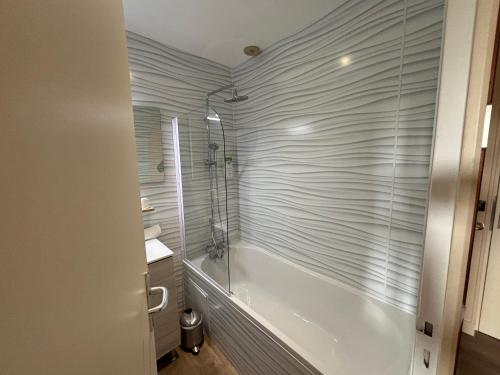 a bathroom with a shower and a tub and a sink at The Originals City, Hôtel La Cour Carrée, EU in Eu