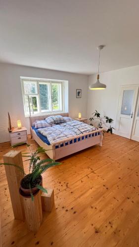 a bedroom with a bed and a wooden floor at Statek Bavorov in Bavorov