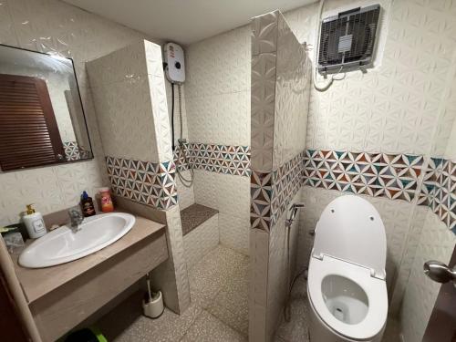 a small bathroom with a toilet and a sink at Noahs Ark Beach in Nathon Bay