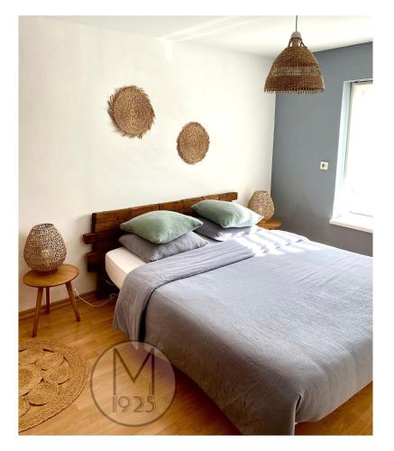 a bedroom with a large bed with two pillows at Maison 1925, Méricourt 62 in Méricourt