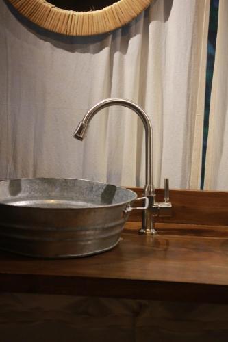 a metal sink with a faucet on a counter at the Roost Tented Camp in Arusha