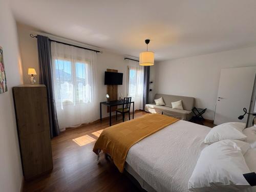 a bedroom with a bed and a living room at Alla Stella B&B in Vo Euganeo