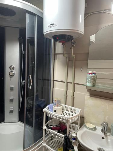 a bathroom with a shower and a sink and a light at Pidkova in Verkhovyna