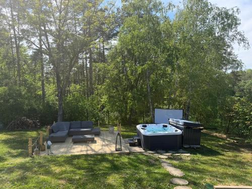 a backyard with a hot tub and a grill at Orfű Hillside in Orfű