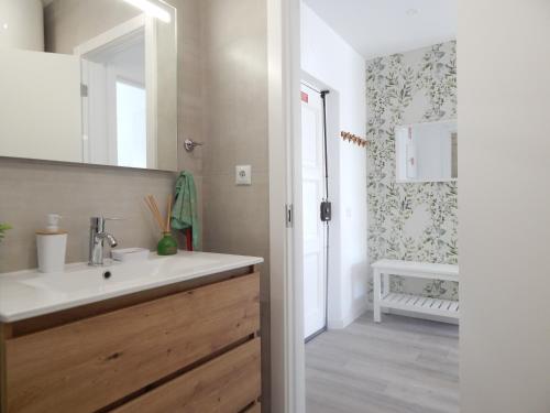 a bathroom with a sink and a mirror at Casa Bella Arch, 2 min walk to beach Praia da Rocha in Portimão