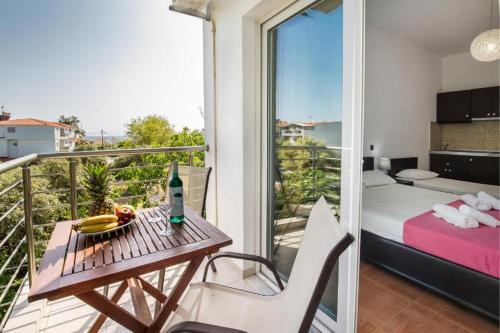 a room with a balcony with a table and a bed at Andronis in Potos