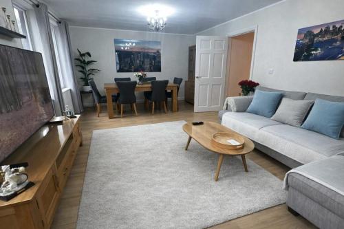 a living room with a couch and a table at 2 Bedroom Flat in Manchester