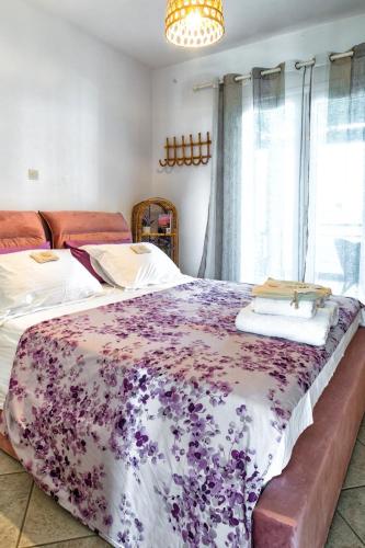 a bedroom with two beds with a purple blanket at Aegean Verde Retreat in Sounio