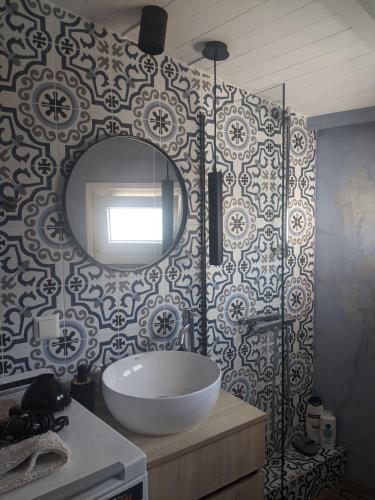 a bathroom with a sink and a mirror on a wall at Aquamarine Centrale in Kavála