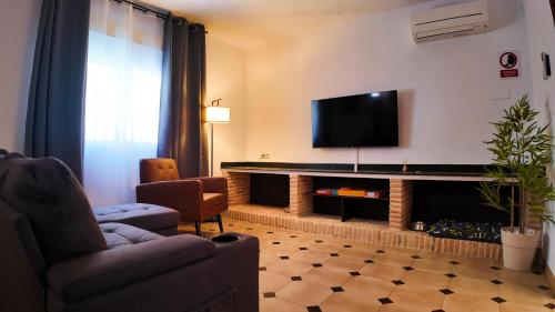 a living room with a flat screen tv on the wall at Ruralux Valentín in Calasparra