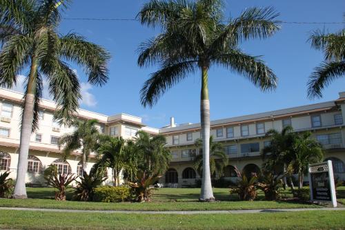a building with palm trees in front of it at Crystal Bay Historic Hotel in St Petersburg