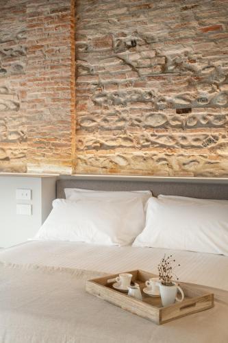 a bedroom with a bed with a brick wall at Suite della Torre in Cavernago