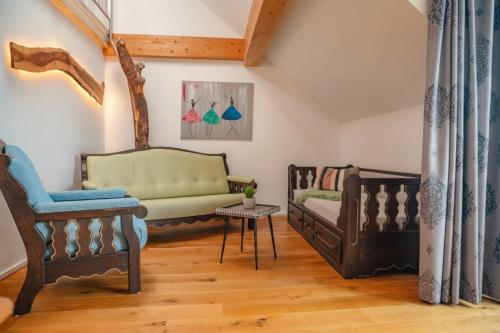a living room with two chairs and a couch at Brunnwirt ESSEN & WOHNEN in Fuschl am See