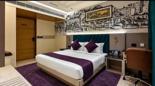 a hotel room with a large bed and a desk at Hotel Pleasant Taj Agra -Budget Family AC Rooms in Tājganj