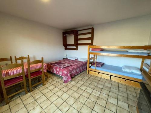 a room with two bunk beds and a bed at Chalet Le Refuge in Samoëns