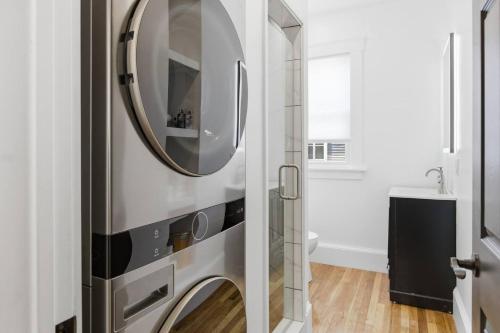 a bathroom with a refrigerator with a mirror on it at Historic home on Salem Neck in Salem