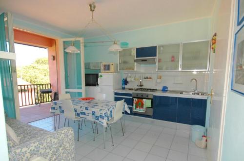 uma cozinha e sala de jantar com mesa e cadeiras em Acquacheta em Marina di Campo