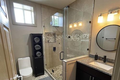 a bathroom with a shower and a sink and a mirror at Buda Casita in Buda