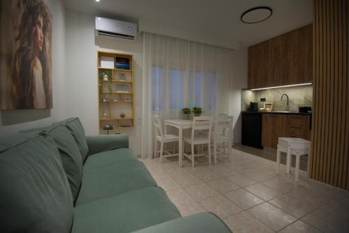 a living room and kitchen with a couch and a table at Casa Nefeli in Karteros