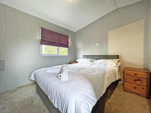 a bedroom with two beds and a window at Brechin Getaway the rowan 2 bedroom static in Angus