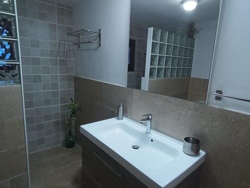 a bathroom with a sink and a mirror at Can Pota in Portocolom