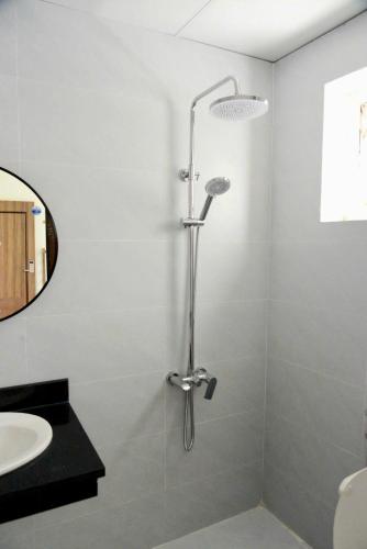 a shower stall in a bathroom with a sink at Tigon Villa in Mỹ Ðuc