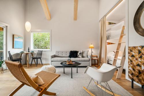 a living room with a couch and a table and chairs at Camp Jackalope - Outdoor Trails - Fire Pit - Views in Wimberley