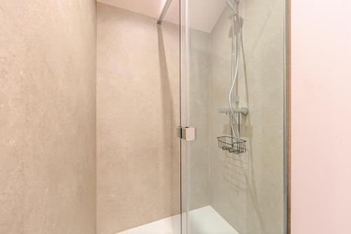 a shower with a glass door in a bathroom at Huyze Aïda in Bruges