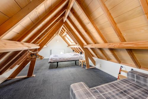 a loft conversion with a bed and a couch at Huyze Aïda in Bruges