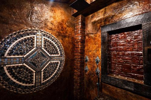 a brick wall with a mosaic design on it at The Miner's Getaway in Lead SD in Lead