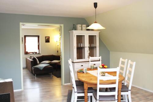 a kitchen and dining room with a table and chairs at Ferienwohnung Fina in Bad Bodenteich