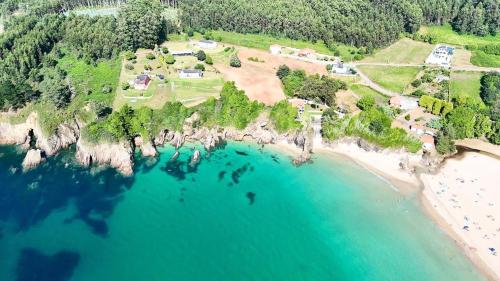 an aerial view of a beach and the ocean at The Cliffs - Morandaina Beach in O Vicedo