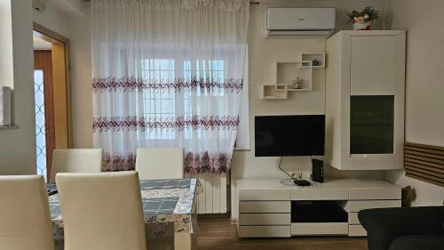 a living room with a television and a window at Apartment Sara in Koper