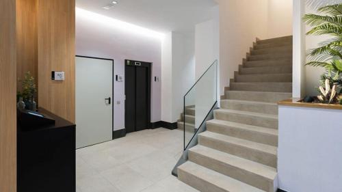 a staircase in a house with a black door at URBANSEA Las Palmas in Las Palmas de Gran Canaria