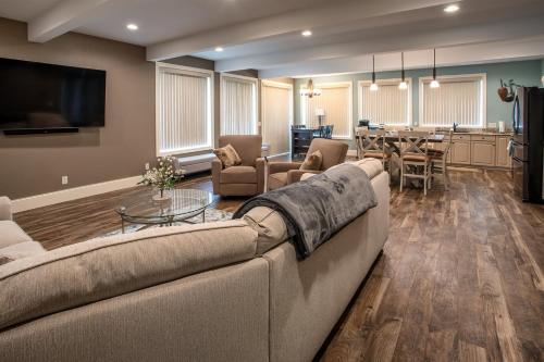 a living room with a couch and a table at Riverview, 5BR, Hot tub, Fireplace, Arcade Game in Minneiska