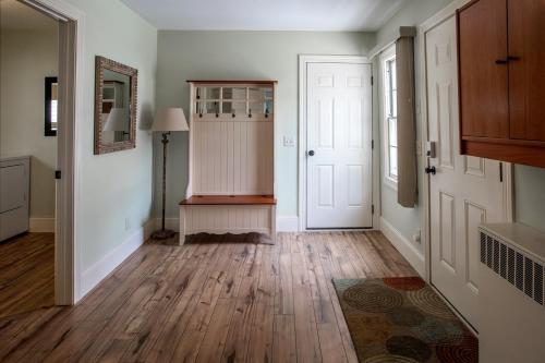 an empty hallway with wooden floors and white doors at Riverview, 5BR, Hot tub, Fireplace, Arcade Game in Minneiska