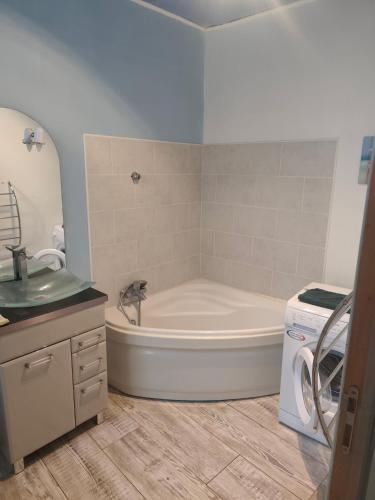 a bathroom with a tub and a sink at superbe t2 centre de cognac in Cognac