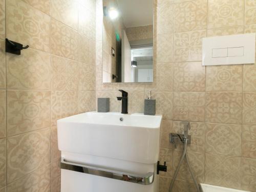 a bathroom with a white sink and a mirror at Zia Elisa Mare e Comfort - Tertenia in Tertenìa