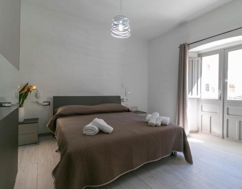 a bedroom with a bed with towels on it at Zia Elisa Mare e Comfort - Tertenia in Tertenìa