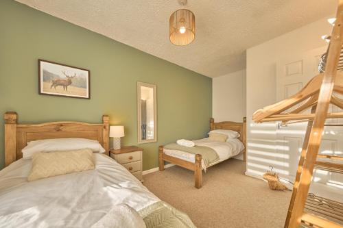 a bedroom with two beds and a ladder at Cosy Peak District Cottage Walk to Town Centre in Fairfield